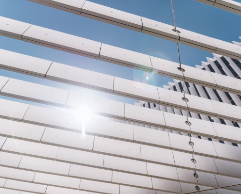 Low angle view of louvre roof against sky on sunny day